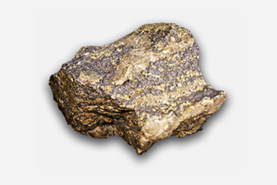 A fragment of molybdenum. It is brown and gold in appearance.