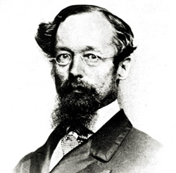 Photo of Alfred Selwyn in a suit and glasses