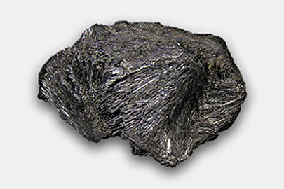 A stibnite – it looks like a black rock with fine grooves on its surface.