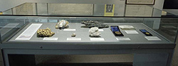 Gold and replica specimens of gold shown in a display cabinet