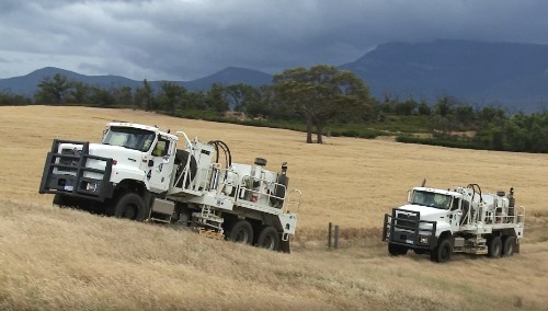 Seismic vibroseis trucks driving in a field